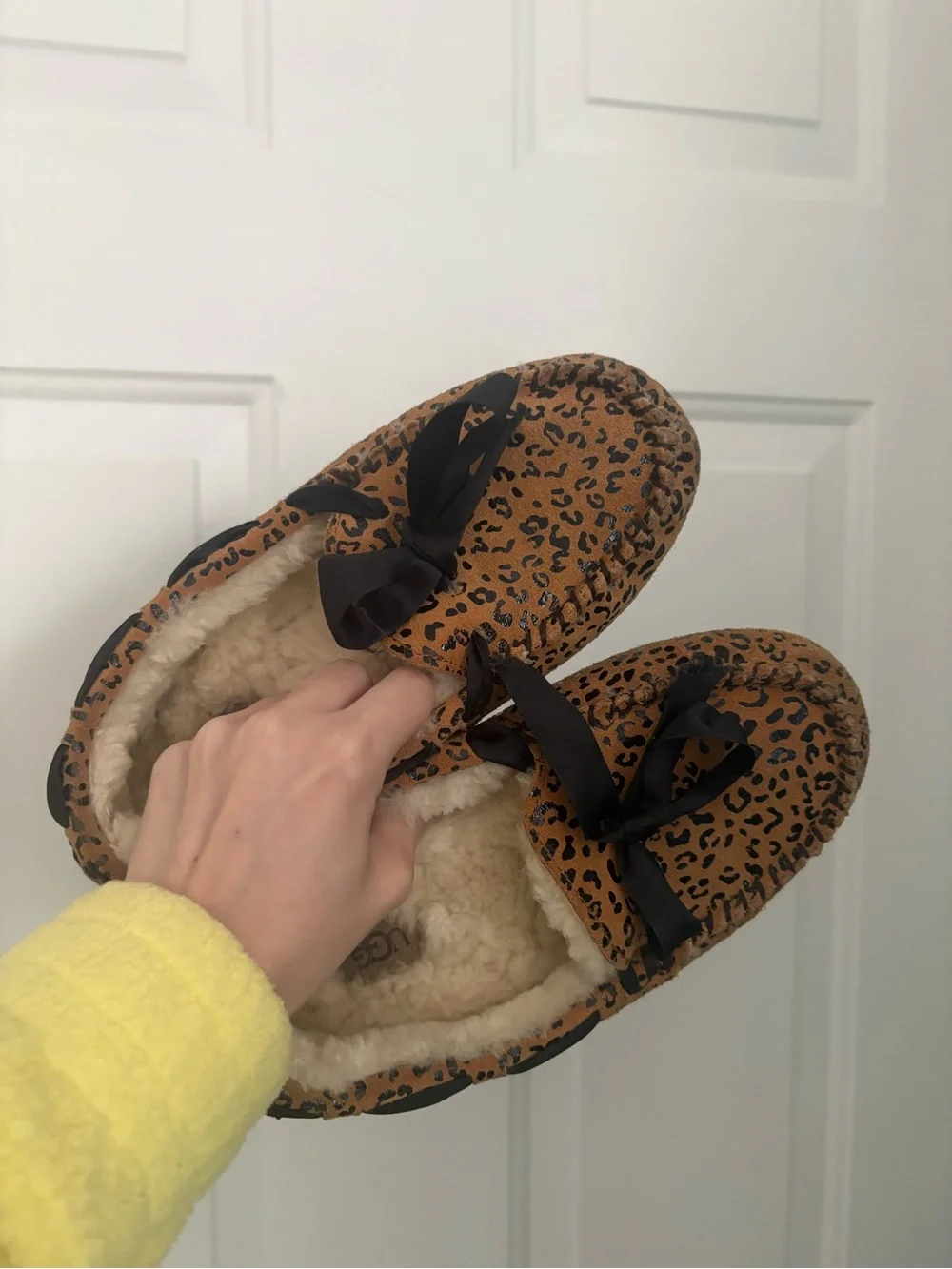 UGG women’s Leopard Print Faux-Fur Lined Slip-Ons in Brown and Black